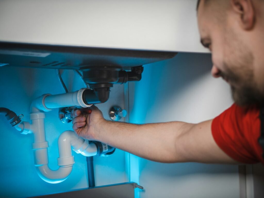 Plumber repairing a water pipe in Dubai
