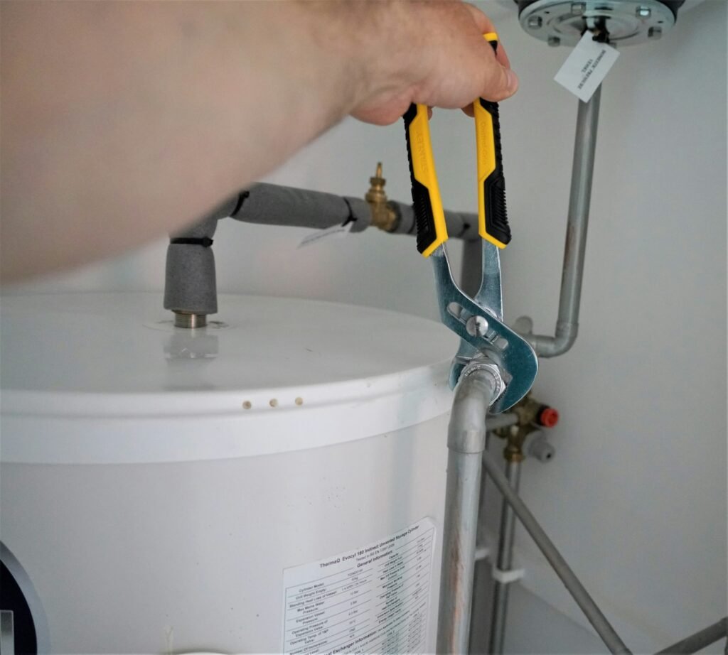 Plumber with tools for water heater repair in Dubai